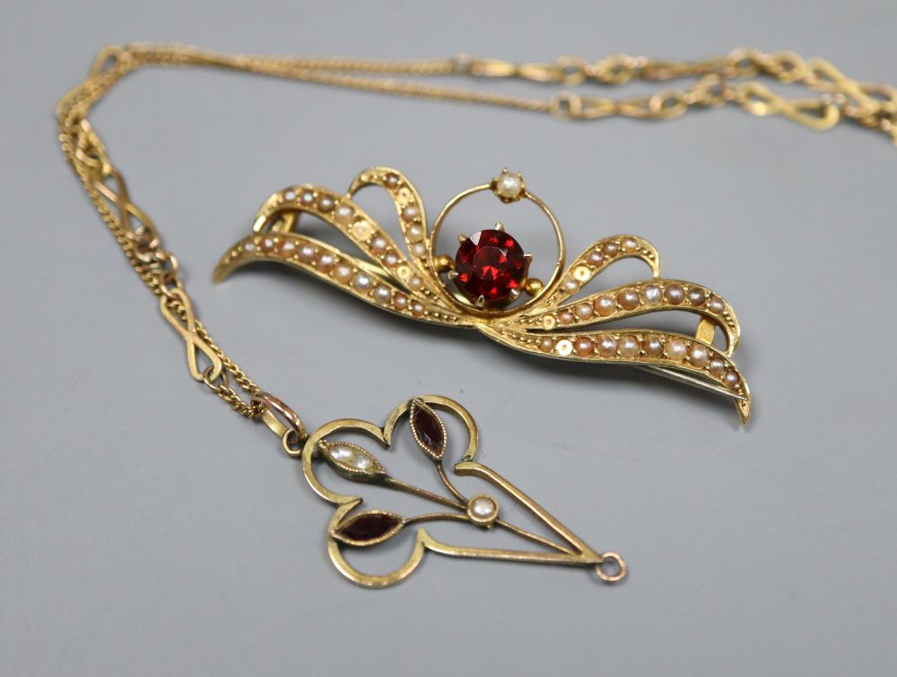 A 15ct, garnet and seed set brooch, 46mm, gross 4.3 grams and a 9ct pendant on a yellow metal chain.